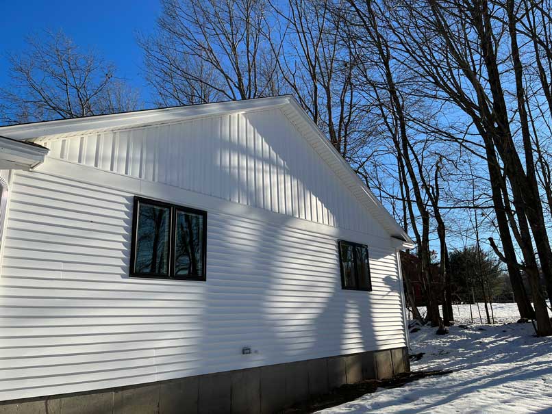This is an image of two Windows installed on a single side of a house in NH.